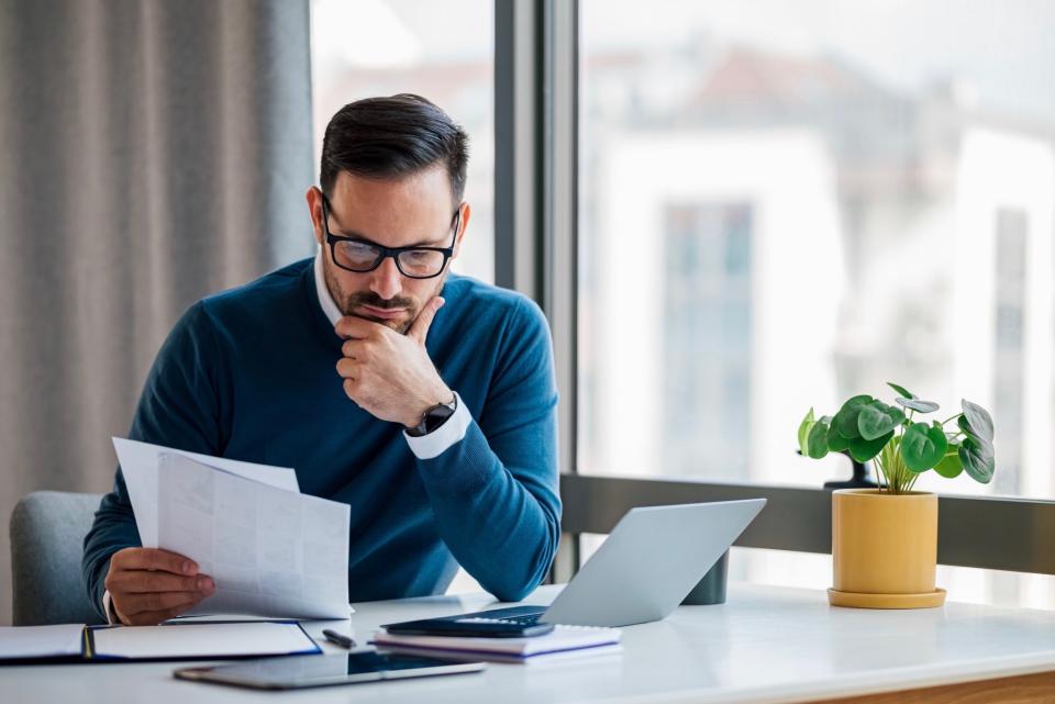 Man looking at papers at work. 