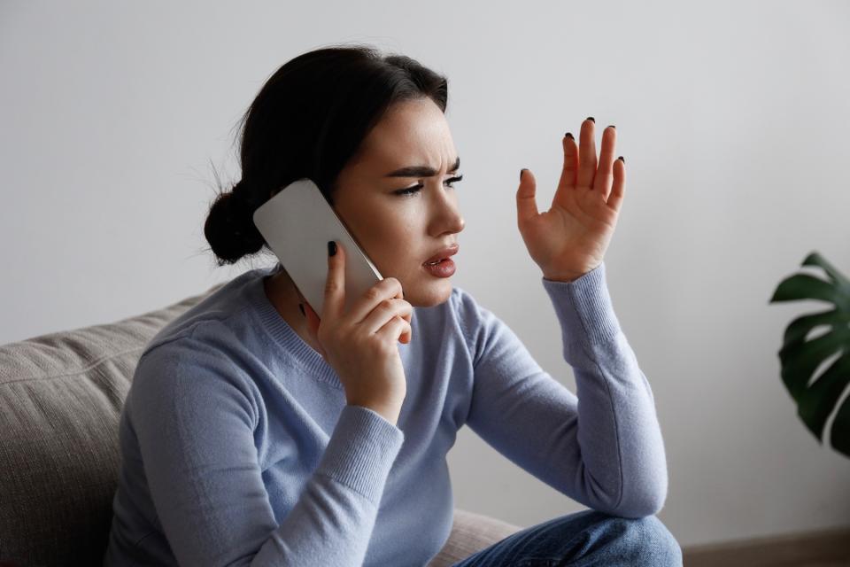 Woman arguing with someone on phone. 