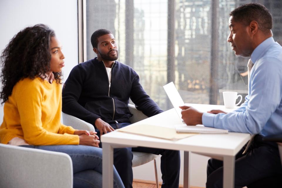 Man and woman meeting with a professional.