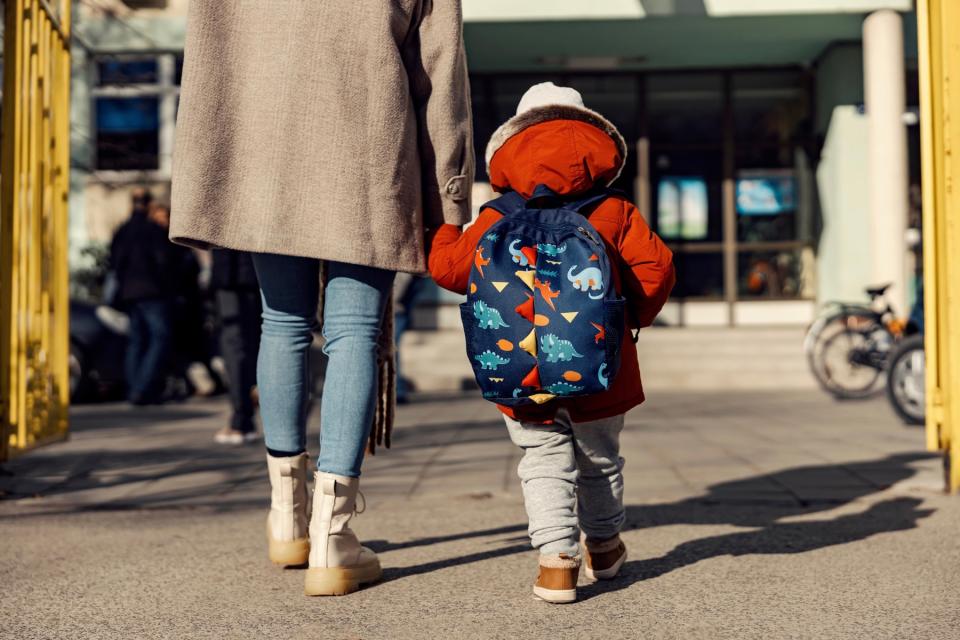 Mom walking child into school.